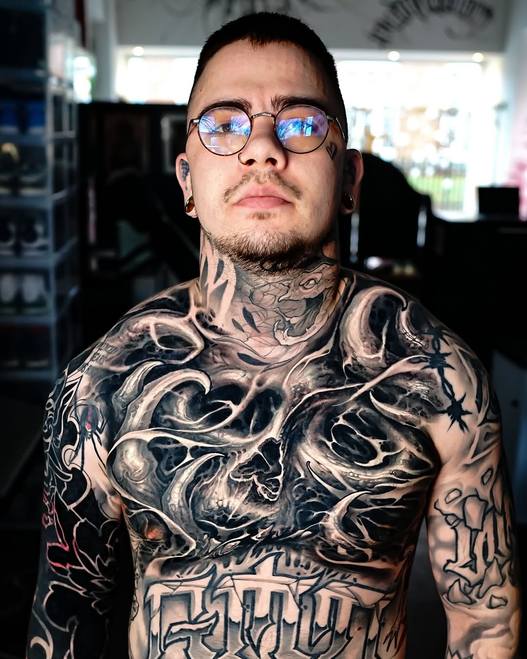 bio-mech skulls and thorns sleeve-to-chest composition with large lower-band lettering