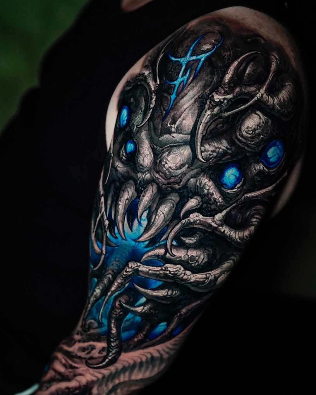 Alien bio-mechanical arm cover-up, blue glow, healed